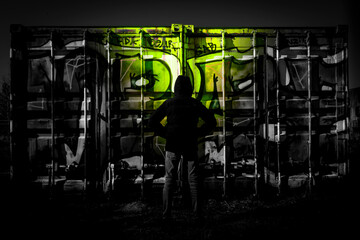 people at night in front of graffiti
