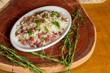 Arroz de Carreteiro - Typical food from southern Brazil, made with rice and dried meat  served on a white plate.