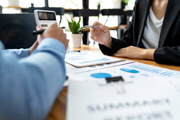Business Asian people are meeting to analyze data figures to plan business strategy with financial paperwork. Business discussing, accounting bookkeeping concept