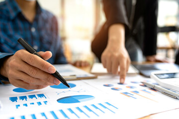 Financial analyst business financial report on a digital tablet during a discussion at a meeting of corporate showing the results of their successful teamwork, business meeting concept, Marketing	