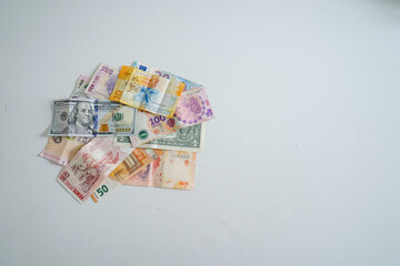 Banknotes from different currencies on white background