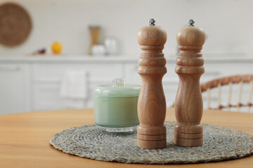 Wooden salt and pepper shakers on table in kitchen, space for text