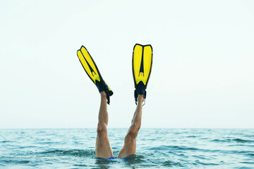Man in flippers diving into sea water, closeup © New Africa