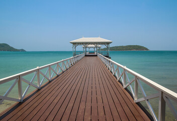 The classic wooden bridge go to white pavilion on the sea in Sri Chang Island ,Thailand