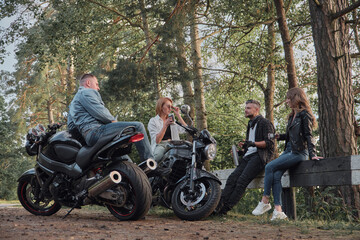 Meeting A company of friends of motorcyclists bikers on motorcycles stopped on the roadside having...