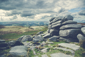 Hill walking on the gritstone outcrops on Higger Tor in the De rbyshire Peak Distrct