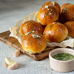 Freshly baked buns (pampushki) with garlic and dill for the first course (soup) on a baking tray. National Ukrainian dish, food. Selective focus.