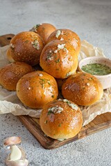 Freshly baked buns (pampushki) with garlic and dill for the first course (soup) on a baking tray. National Ukrainian dish, food. Selective focus.