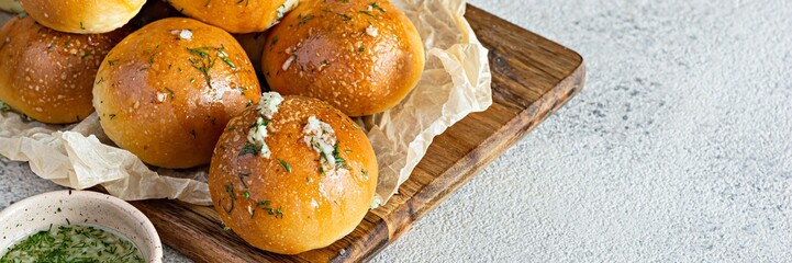 Freshly baked buns (pampushki) with garlic and dill for the first course (soup) on a baking tray. National Ukrainian dish, food. Selective focus.