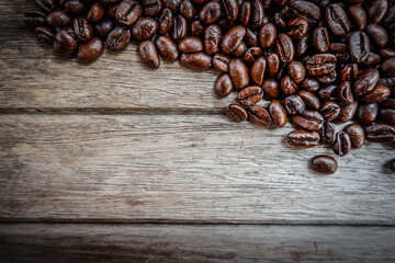 Roasted coffee beans on wooden background