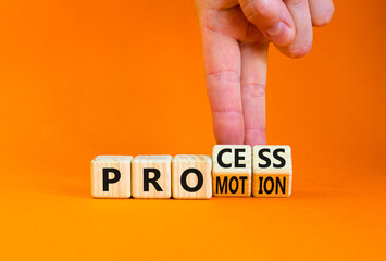 Process and promotion symbol. Concept words Process and promotion on wooden cubes. Businessman hand. Beautiful orange table orange background. Business process and promotion concept. Copy space.