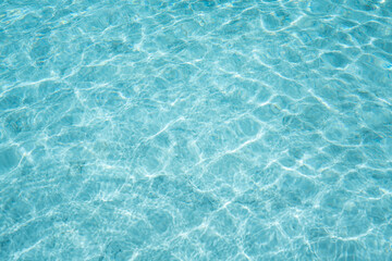 surface of blue and bright water in swimming pool