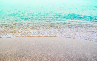 wave of blue ocean on sandy beach