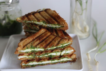 Cheese chutney sandwich. Grilled sandwiches with cottage cheese slices and green garlic condiments. Cheese chutney sandwich.