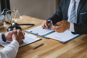 The lawyer working with a client discussing contract paper, a Business lawyer working about legal legislation in the courtroom to help their customer