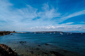 Boats anchored in the crystal clear waters of the island of Tabarca, in front of Santa Pola in the Spanish Mediterranean