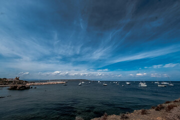 Boats anchored in the crystal clear waters of the island of Tabarca, in front of Santa Pola in the Spanish Mediterranean
