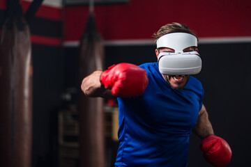 Medium close up and motion blur of sport man wearing VR headset to exercise with simulation boxing games, Young man athlete boxer virtual reality combat experience activity. New Experience lifestyle.