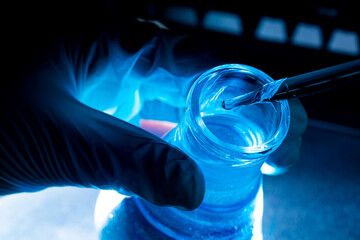 blue glass test tube,Asian female scientist with test tubes doing research in clinical laboratories...