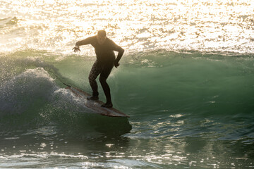 Surfer in action at sunset