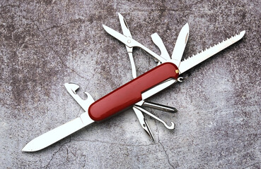 A picture of red multitool on stone floor.