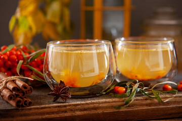 Hot vitamin drink made from fresh sea buckthorn berries. Close-up, selective focus