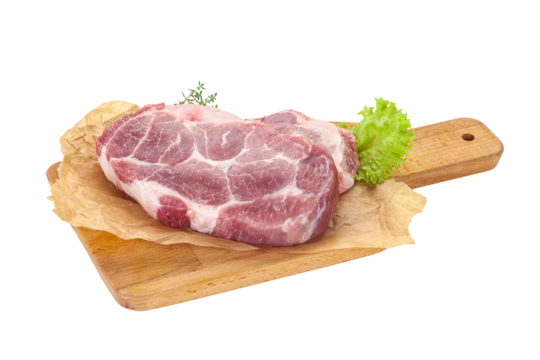 Raw pork steak over wooden board