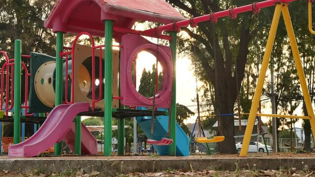 playground in the park. The empty swing was swinging back and forth. Missing children and kidnapping concepts