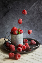 Fresh, fragrant raspberries, waffles, honey and just raspberries falling on a dark background.