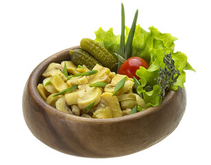 Marinated mushrooms in white saucer isolated on white