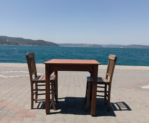a table and two chairs waiting for a couple to sit.