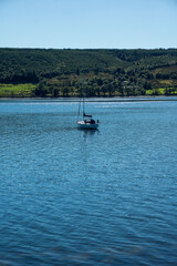 Fototapeta na wymiar Landscape of Gare Loch with single sail boat
