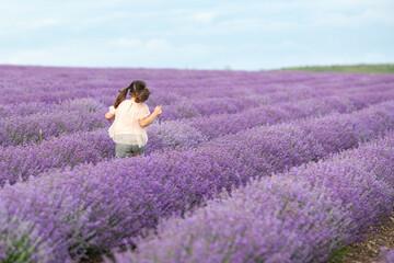 Happy girl in the lavender field. child running