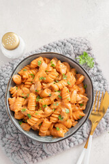 Fusilli pasta with chicken. Cooked in spicy sauce from tomatoes, onion, garlic with chicken meat