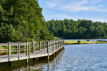 Fototapeta na wymiar Wooden pier on lake McIntosh in Peachtree City Georgia.