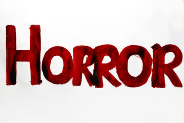 Word Horror written by blood. Halloween, abuse, destruction concept