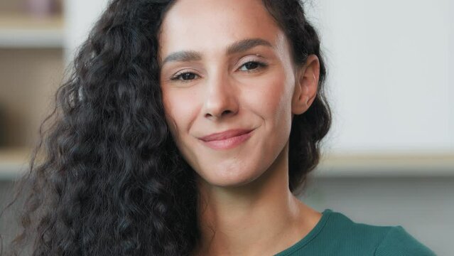Portrait curly woman posing indoors soft smiling face of beautiful arabian hispanic lady nodding head positive yes answer agree approve good reaction right decision understand accept confirm approval