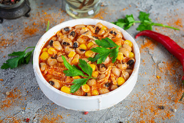 Chili con carne in a bowl. Mexican cuisine. Chili with meat, corn and beans