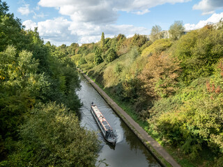 Canal Boat cruising along BCN New Main Line about to go under Galton Bridge