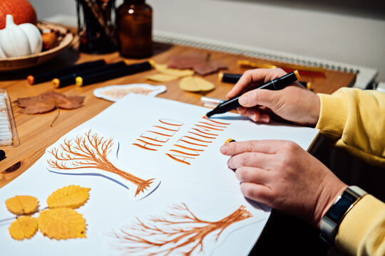 Hello Autumn lettering. Autumn Season Drawing, How to draw fall lettering drawing and painting. Fall lettering on the table with paints, brushes and autumn leaves