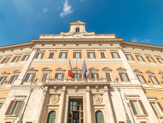 Fototapeta na wymiar Montecitorio Palace under a blue sky with clouds