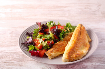 Fried fillet of sea bass fish served