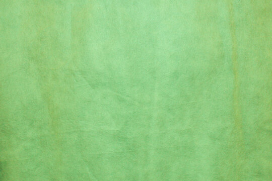 Green color felt textile fabric material texture background.