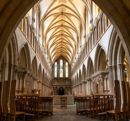 view of the central nave and altar inside the historic Wells Cathedral in Somerset - obrazy, fototapety, plakaty