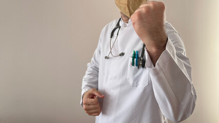 A doctor in a white coat, yellow mask, gray stethoscope, copy space