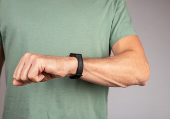 Use black smart fitness watch, bracelet on male hand. High quality photo