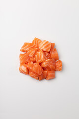 Diced pieces of juicy fresh salmon on a white background