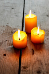 Obraz na płótnie Canvas Candles on wooden table, cozy atmosphere.