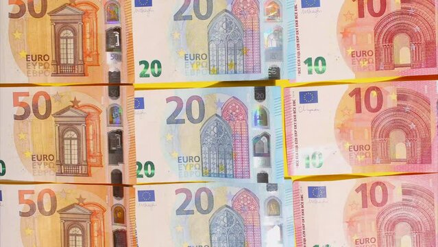 Stop Motion animation. Euro cash macro view. Financial Crisis. Texture. Finance Business Investment Success Concept. Euro money 50, 10, 20 euro bills view from the top on the yellow background