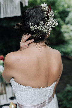 Young beautiful bride holding bouquet in boho style